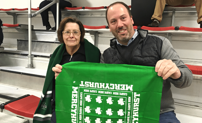 Showdown Tournaments Brian Harrington with his mom, Jean holding a Mercyhurst Hockey Rally Flag