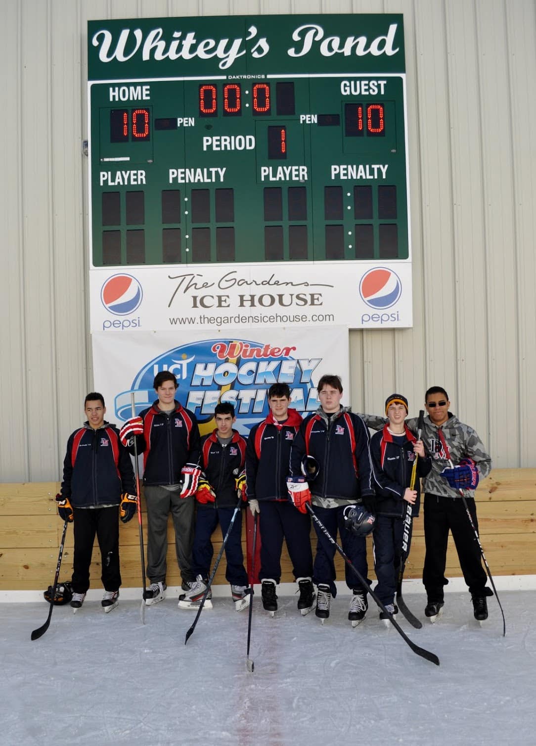 high school hockey players on ice, earning service hours at a hockey tournament