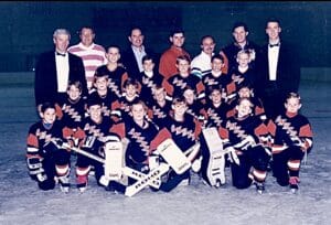Gene Harrington and Brian Harrington with their youth hockey team